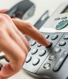 Image of Person Dialing Phone for Telephone Banking