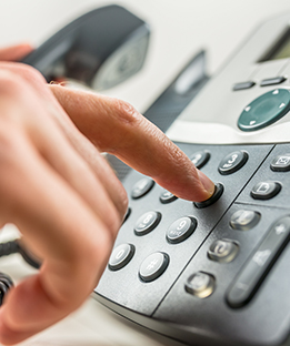 Image of Person Dialing Phone for Telephone Banking