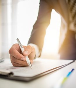 Image of Person Writing Business Lending Check