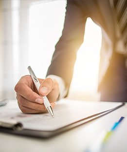 Image of Person Writing Business Lending Check