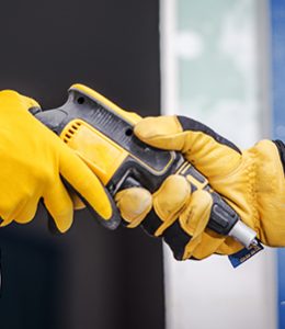 Image of Workers Passing a Drill for New and Used Equipment