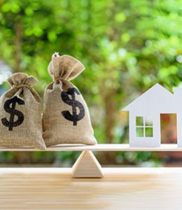 Image of a House and Money Bags on a Scale for Home Equity Loans