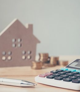 Image of a House and Calculator for Mortgage Loans