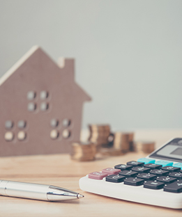 Image of a House and Calculator for Mortgage Loans